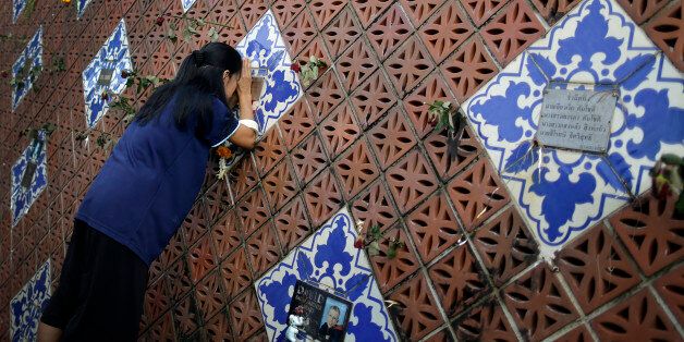 A woman offers prayers on a tiled memorial wall displaying names of victims from the Asian tsunami, Friday, Dec. 26, 2014 in Phang Nga, Ban Namn Khem province, Thailand. Dec. 26 marks the 10th anniversary of one of the deadliest natural disasters in world history: a tsunami, triggered by a massive earthquake off the Indonesian coast, that left more than 230,000 people dead in 14 countries and caused about $10 billion in damage. (AP Photo/Wong Maye-E)