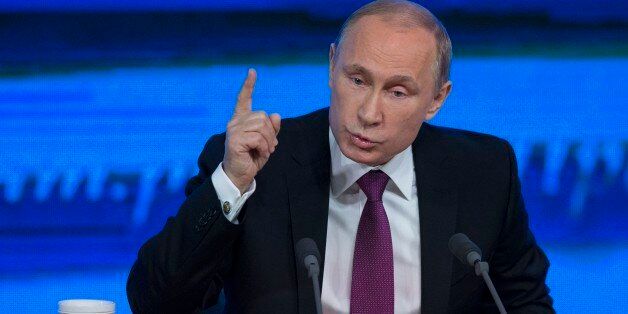 Russian President Vladimir Putin gestures during his annual news conference in Moscow, Russia, Thursday, Dec. 18, 2014. The Russian economy will rebound and the ruble will stabilize, Russian President Vladimir Putin said Thursday at his annual press conference, he also said Ukraine must remain one political entity, voicing hope that the crisis could be solved through peace talks. (AP Photo/Pavel Golovkin)
