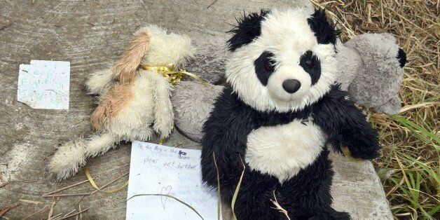 Teddy bears and notes of support are displayed on the cover of a 2.5-metre-deep (8.2-feet) deep drain in the outer Sydney suburb of Quakers Hill on November 25, 2014, following an Australian mother being charged with attempted murder after her newborn baby was found crying at the bottom of the roadside drain, where police believe he survived for five days. Passing cyclists heard wailing coming from the drain on a bike path along a western Sydney highway early morning on November 23. AFP PHOTO / William WEST (Photo credit should read WILLIAM WEST/AFP/Getty Images)