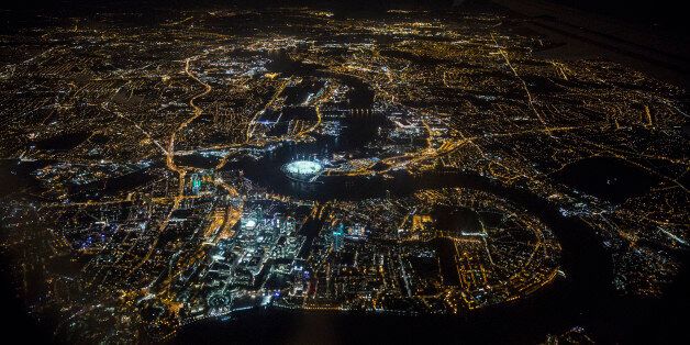 LONDON, ENGLAND - MAY 20: An aerial view of the buildings and streets of London, including the O2 Arena and the Canary Wharf development on the Isle of Dogs, which are illuminated at night on May 20, 2014 in London, England. (Photo by Oli Scarff/Getty Images)