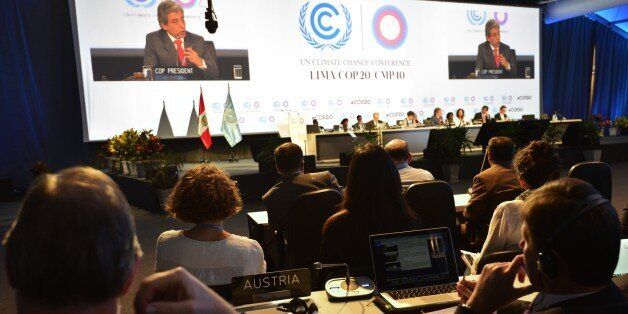 COP20 President and Peruvian Minister of Environment Manuel Pulgar (on screen) addresses representatives on December 12, 2014, during the UN COP20 and CMP10 climate change conferences being held in Lima. The UN 20th session of the Conference of the Parties on Climate Change (COP20), and the 10th session of the Conference of the Parties serving as the Meeting of the Parties to the Kyoto Protocol (CMP10) finishes on December 12. AFP PHOTO/CRIS BOURONCLE (Photo credit should read CRIS BOURONCLE/AFP/Getty Images)