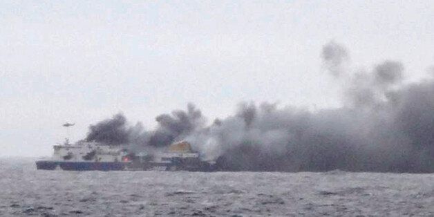 In this photo taken from a nearby ship, smoke rises from the Italian-flagged Norman Atlantic after it caught fire in the Adriatic Sea, Sunday, Dec. 28, 2014. The ferry carrying hundreds of passengers caught fire off the Greek island of Corfu early Sunday, trapping passengers on the top decks as gale-force winds and choppy seas hampered the evacuation. (AP Photo/SKAI TV Station) GREECE OUT, MANDATORY CREDIT
