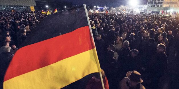 Participants of a rally called 'Patriotic Europeans against the Islamization of the West' (PEGIDA) hold German flags during a demonstration in Dresden, eastern Germany, Monday, Dec. 15, 2014. Pegida, a nascent anti-foreigner campaign group, is growing in stature week by week and sparking concern among German officials. For the past nine weeks, activists protesting Germanyâs immigration policy and the spread of Islam in the West have been marching each Monday. (AP Photo/Jens Meyer)