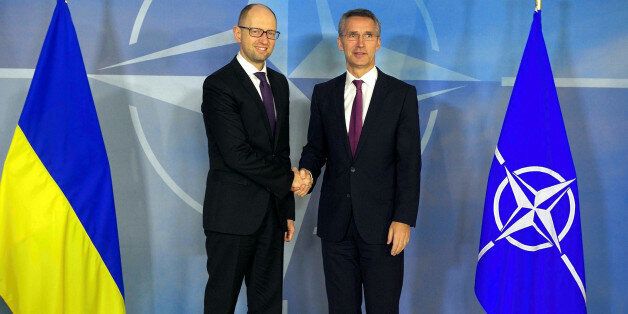 BRUSSELS, BELGIUM - DECEMBER 15: Ukraine's Prime Minister Arseniy Yatsenyuk (L) and North Atlantic Treaty Organization (NATO) Secretary General Jens Stoltenberg (R) shake hands during a joint press conference after their meeting in Brussels, Belgium on December 15, 2014. (Photo by Dursun Aydemir/Anadolu Agency/Getty Images)