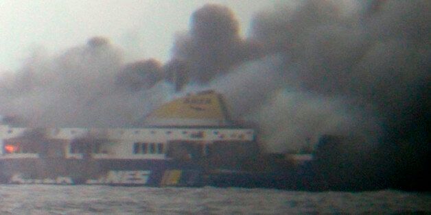 In this photo taken from a nearby ship, smoke rises from the Italian-flagged Norman Atlantic ferry after it caught fire in the Adriatic Sea, Sunday, Dec. 28, 2014. The ferry carrying some hundreds of passengers caught fire off the Greek island of Corfu early Sunday, trapping passengers on the top decks as gale-force winds and choppy seas hampered their evacuation. (AP Photo/SKAI TV Station) GREECE OUT, MANDATORY CREDIT