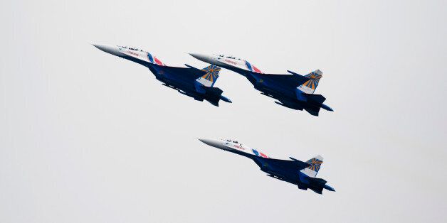 Russian Air Force Knights SU-27 jets, manufactured by Sukhoi Co., fly during an aerobatics display at the China International Aviation & Aerospace Exhibition in Zhuhai, Guangdong province, China, on Wednesday, Nov. 12, 2014. The air show takes place from Nov. 11-16. Photographer: Brent Lewin/Bloomberg via Getty Images