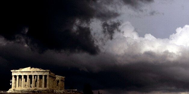 Dark clouds pass over a semi-sunlit Parthenon temple atop the ancient Acropolis Hill in Athens on Monday, March 13, 2006. Restoration work is currently ongoing at Greece's most famous monument. (AP Photo/Petros Giannakouris)