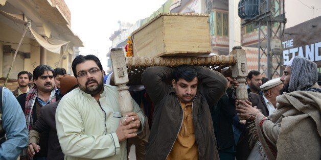 Pakistani mourners carry a coffin during the funeral ceremony for victims of an attack by Taliban militants at an army-run school, in Peshawar on December 17, 2014. Pakistan began three days of mourning on December 17 for the 132 schoolchildren and nine staff killed by the Taliban in the country's deadliest ever terror attack as the world united in a chorus of revulsion. AFP PHOTO / A MAJEED (Photo credit should read A Majeed/AFP/Getty Images)