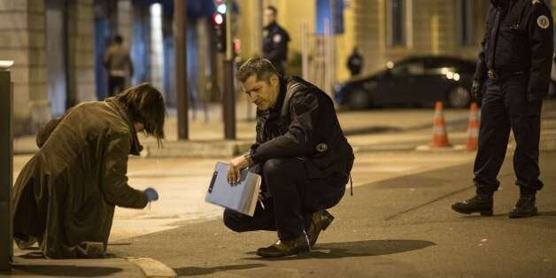 Policemen collect evidence on December 21, 2014 in Dijon on the site where a driver shouting 'Allahu Akbar' ('God is great') ploughed into a crowd injuring 11 people, two seriously, a source close to the investigation said. Two of the people injured in the car attack in the city of Dijon were in a serious condition, a police source said, adding that the driver had been arrested. AFP PHOTO / ARNAUD FINISTRE (Photo credit should read ARNAUD FINISTRE/AFP/Getty Images)