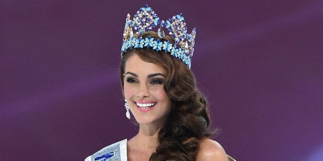 Miss South Africa and the 2014 Miss World, Rolene Strauss, poses in her seat after eing crowned during the grand final of the Miss World 2014 pageant at the Excel London ICC Auditorium in London on December 14, 2014. AFP PHOTO / LEON NEAL (Photo credit should read LEON NEAL/AFP/Getty Images)