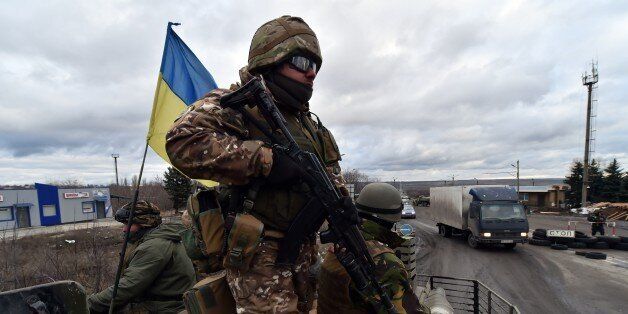 Ukrainian soldiers ride on a armored personnel vehicle outside the eastern Ukrainian city of Debaltseve, Donetsk region, on December 24,2014. A new round of talks aimed at ending a protracted Moscow-backed separatist uprising in eastern Ukraine got underway in the Belarussian capital Minsk, a foreign ministry spokesman said. AFP PHOTO/ SERGEI SUPINSKY (Photo credit should read SERGEI SUPINSKY/AFP/Getty Images)