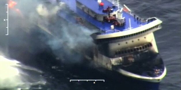 In this image taken from a video released by the Italian Coast Guard, smoke billows from the Italian-flagged Norman Atlantic that caught fire in the Adriatic Sea, Sunday, Dec. 28, 2014. Italian and Greek rescue crews battled gale-force winds and massive waves as they struggled Sunday to evacuate hundreds of people from a ferry on fire and adrift in the channel between Italy and Albania. At least one person died and two were injured. The fire broke out before dawn Sunday on a car deck of the Italian-flagged Norman Atlantic, traveling from the western Greek port of Patras to the Italian port of Ancona on the Adriatic, with 422 passengers and 56 crew members on board. (AP Photo/Italian Coast Guard)