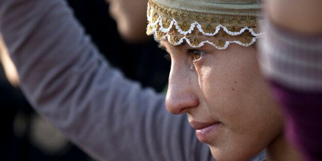 A girl cries during the funeral of 19 year-old Syrian Kurdish fighter girl Perwin Mustafa Dihap who died after being wounded during fighting against the Islamic State forces in her home town of Kobani, in Suruc, on the Turkey-Syria border Friday, Nov. 7, 2014. Kobani, also known as Ayn Arab, and its surrounding areas, has been under assault by extremists of the Islamic State group since mid-September and is being defended by Kurdish fighters. (AP Photo/Vadim Ghirda)