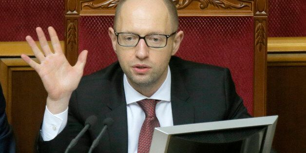 Ukrainian Prime Minister Arseniy Yatsenyuk speaks to lawmakers during the parliament session in Kiev, Ukraine, Tuesday, Oct. 7, 2014. Parliament overwhelmingly adopted a raft of anti-corruption legislation in its first reading Tuesday and is expected to pass the laws definitively later in the month. (AP Photo/Efrem Lukatsky)
