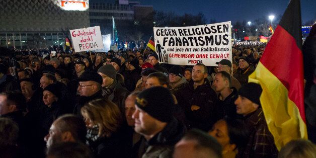 DRESDEN, GERMANY - DECEMBER 8: Supporters of the Pegida movement take part in a rally on December 8, 2014 in Dresden, Germany. Pegida is an acronym for 'Patriotische Europaeer Gegen die Islamisierung des Abendlandes,' which translates to 'Patriotic Europeans Against the Islamification of the Occident,' and has quickly gained a spreading mass appeal by demanding a more restrictive policy on Germany's acceptance of foreign refugees and asylum seekers. While Pegida disavows xenophobia in its public