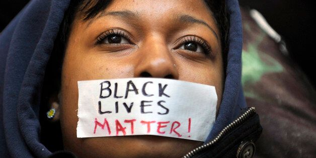 Penn State student Zaniya Joe wears a piece of tape over her mouth that says 'Black Lives Matter' during a Ferguson protest organized by a group of Penn State University students on Tuesday, Dec. 2, 2014, in University Park, Pa. (Nabil K. Mark/Centre Daily Times/TNS via Getty Images)