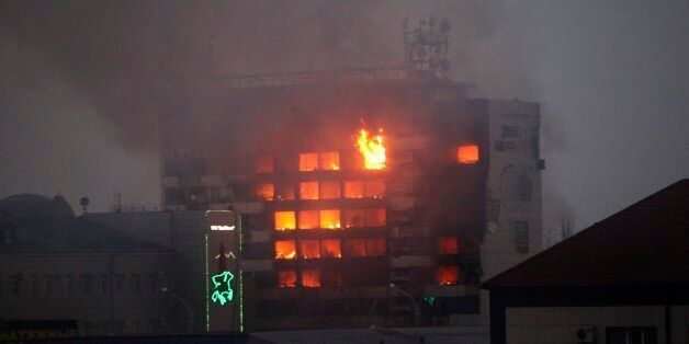 A publishing house building is seen in flames in the center of Grozny, Russia, early Thursday, Dec. 4, 2014. A gun battle broke out after midnight Thursday in the capital of Russiaâs North Caucasus republic of Chechnya, puncturing the patina of stability ensured by years of heavy-handed rule by a Kremlin-appointed leader. Security officials and the leader of Chechnya said gunmen traveling in several cars killed at least three traffic police officers at a checkpoint late at night in the capi