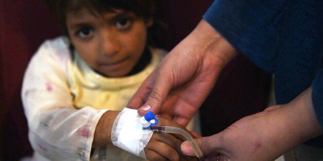 A Pakistani Thalassaemia patient receives blood at a treatment center in Peshawar on December 4, 2014. Ten Pakistani children, from the cities of Islamabad, Rawalpindi and Lahore, have been infected with HIV after receiving tainted blood transfusions, officials said, in a 'shocking' case highlighting the abysmal state of blood screening in the country. Dr Yasmin Rashid, secretary general of the Thalassaemia Federation of Pakistan,said that it was hard to pinpoint at this stage which blood banks