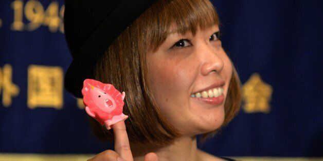 Japanese artist Megumi Igarashi, who calls herself Rokude Nashiko, shows a small mascot shaped like a vagina 'Manko-chan' at a news conference in Tokyo on July 24, 2014. Igarashi, who has created genital-inspired artworks and was arrested on obscenity charges last week, was released from police custody on July 18, a case which supporters said was an attack on free expression. AFP PHOTO / Yoshikazu TSUNO (Photo credit should read YOSHIKAZU TSUNO/AFP/Getty Images)