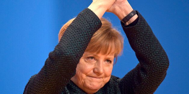 German Chancellor and chairwoman of the German Christian Democrats, CDU, Angela Merkel, thanks the delegates for standing ovations after her speech at the 27. party convention in Cologne, Germany, Tuesday, Dec. 9, 2014. (AP Photo/Martin Meissner)