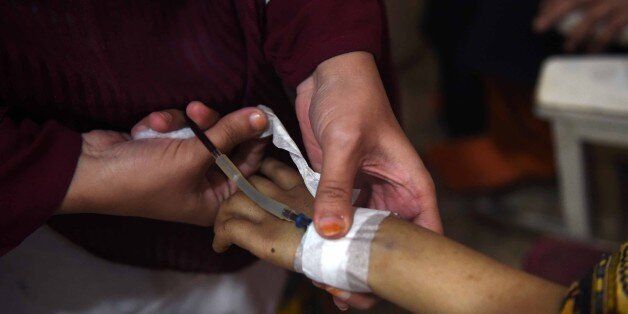 A Pakistani Thalassaemia patient receives blood at a treatment center in Peshawar on December 4, 2014. Ten Pakistani children, from the cities of Islamabad, Rawalpindi and Lahore, have been infected with HIV after receiving tainted blood transfusions, officials said, in a 'shocking' case highlighting the abysmal state of blood screening in the country. Dr Yasmin Rashid, secretary general of the Thalassaemia Federation of Pakistan,said that it was hard to pinpoint at this stage which blood banks were the culprits. AFP PHOTO/A MAJEED (Photo credit should read A Majeed/AFP/Getty Images)