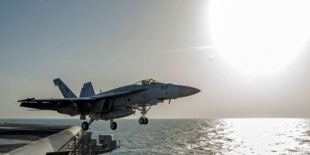 In this image released by the U.S. Navy on Friday, Dec. 5, 2014, a fighter jet launches from the flight deck of the Nimitz-class aircraft carrier USS Carl Vinson (CVN 70) as the ship conducts flight operations in the U.S. 5th Fleet area of operations supporting Operation Inherent Resolve targeting Islamic State militants in Iraq and Syria. (AP Photo/Mass Communication Specialist 2nd Class John Philip Wagner Jr., U.S. Navy)