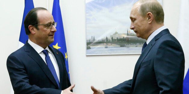 Russian President Vladimir Putin, right, approaches to shake hands with his French counterpart Francois Hollande during their meeting at Moscow's Vnukovo airport, Saturday, Dec. 6, 2014. The French leader met with Vladimir Putin at a Moscow airport on Saturday in an unexpected stopover visit, as he traveled from neighboring Kazakhstan back to Paris. (AP Photo/Maxim Zmeyev, Pool)