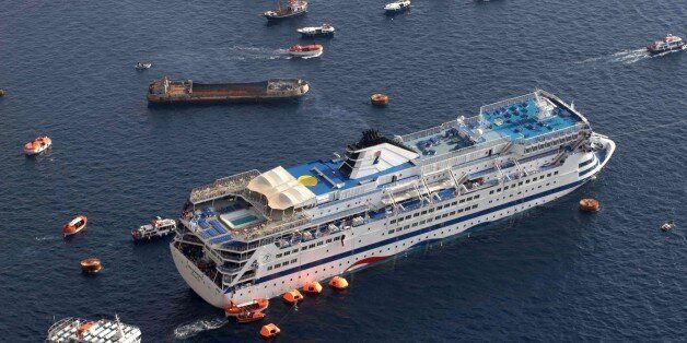 The listing cruise ship 'Sea Diamond' carrying nearly 1,200 passengers is seen surrounded by over a dozen ships involved in the evacuation effort, in Santorini, Greece, Thursday, April 5, 2007. (AP Photo/Eurokinissi) ** GREECE OUT **