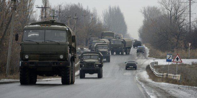 A military convoy of about 30 trucks without license plates coming from the east moves on the road on November 29, 2014 in Chartcizsk. Ukraine's military said on November 27, 2014 that two civilians had been killed and eight wounded by fighting over the past 24 hours. Seven months of brutal fighting have cost the lives of over 4,300 people in the east of the country in the conflict between Ukrainian forces and pro-Russia rebels. AFP PHOTO / ERIC FEFERBERG (Photo credit should read ERIC FEFERBERG/AFP/Getty Images)