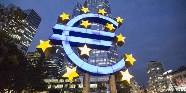 A euro sign sculpture stands illuminated in front of the European Central Bank (ECB) headquarters in Frankfurt, Germany, on Thursday, Oct. 23, 2014. At noon in Frankfurt on Oct. 26, investors will learn which of the currency bloc's 130 biggest banks fell short in the ECB's year-long examination of their asset strength and ability to withstand economic turbulence. Photographer: Martin Leissl/Bloomberg via Getty Images