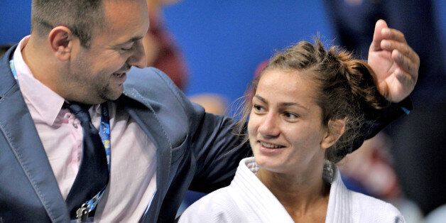 RIO DE JANEIRO, BRAZIL - AUGUST 27: Majlinda Kelmendi of Kosovo is congratulated by her coach, Dritton Kuka, after winning the u52kgs final during day 2 of the Rio World Judo Championships at the Gympasium Maracanazinho on August 27, 2013 in Rio de Janeiro, Brazil. (Photo by David Finch/Getty Images)