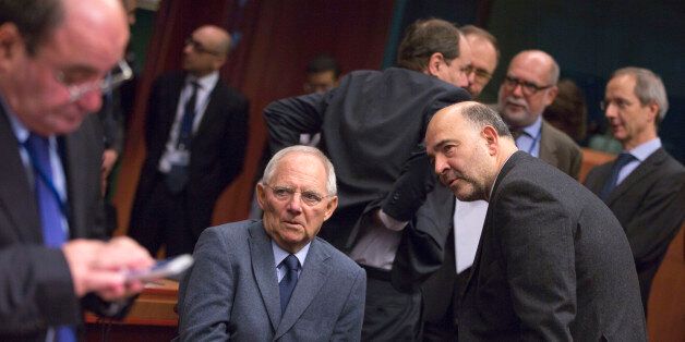 European Commissioner for Economic and Financial Affairs Pierre Moscovici, center right, speaks with German Finance Minister Wolfgang Schaeuble, center left, during a meeting of the eurogroup finance ministers at the EU Council building in Brussels on Monday, Dec. 8, 2014. (AP Photo/Virginia Mayo)