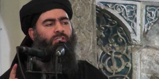 This image made from video posted on a militant website Saturday, July 5, 2014, which has been authenticated based on its contents and other AP reporting, purports to show the leader of the Islamic State group, Abu Bakr al-Baghdadi, delivering a sermon at a mosque in Iraq. A video posted online Saturday purports to show the leader of the Islamic State extremist group that has overrun much of Syria and Iraq delivering a sermon at a mosque in Iraq, in what would be a rare - if not the first - public appearance by the shadowy militant. (AP Photo/Militant video)
