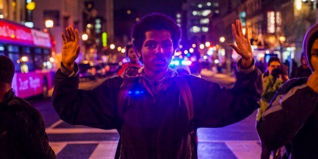 WASHINGTON, DC - DECEMBER 5 : Protesters demonstrate on the streets of Washington during a protest after two grand juries decided not to indict the police officers involved in the deaths of Michael Brown in Ferguson, Mo. and Eric Garner in New York, N.Y. in Washington, D.C. on December 5, 2014. (Photo by Samuel Corum/Anadolu Agency/Getty Images)