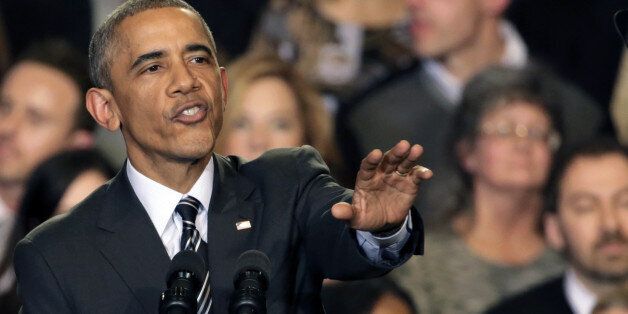 President Barack Obama tries to quiet one of three hecklers as he addresses the crowd after meeting with community leaders about the executive actions he is taking to fix the immigration system Tuesday, Nov. 25, 2014, in Chicago. (AP Photo/Charles Rex Arbogast)