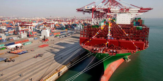 QINGDAO, CHINA - DECEMBER 04: (CHINA OUT) The maiden voyage ceremony of the world largest container ship 'CSCL Globe' is held at Port of Qingdao on December 4, 2014 in Qingdao, Shandong province of China. The 'CSCL Globe' is the first ship co-built by China Shipping container Lines Co.,Ltd and Hyundai Heavy Industries Ltd. Co of South Korea. CSCL Globe measures 400m in length, 58.6m in width and 30.5m in depth. (Photo by ChinaFotoPress/ChinaFotoPress via Getty Images)