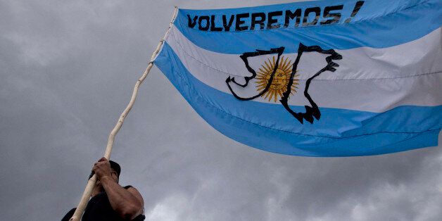 A man holds Argentina's national with a message that reads in Spanish;