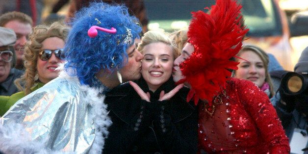 CAMBRIDGE, MA - FEBRUARY 15: Actress Scarlett Johansson is paraded through Harvard Square alongside Justin Rodriguez (L) and Josh Brenner of Harvard University's Hasty Pudding Theatricals during festivities February 15, 2007 in Cambridge, Massachusetts. Johanson was named woman-of-the-year by the group, the nation's oldest undergraduate theater group for her contribution to the arts. (Photo by Darren McCollester/Getty Images)