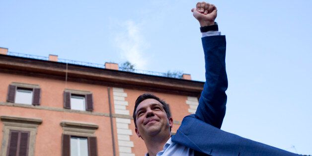 Leader of the left-wing Syriza party Alexis Tsipras,waves at the end of a rally in Rome, Friday, July 18, 2014. (AP Photo/Alessandra Tarantino)