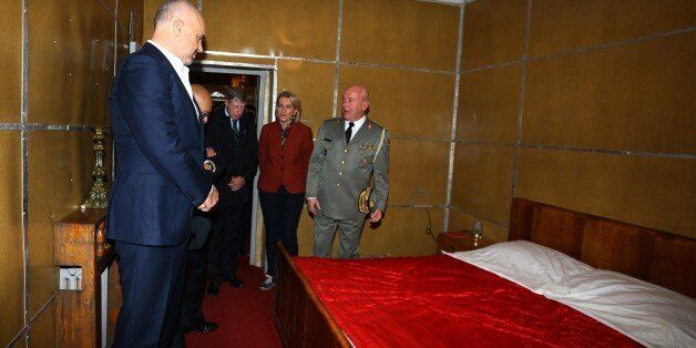 Albanian Prime Minister Edi Rama, left, looks at the bedroom of late communist dictator Enver Hoxha at a bunker built in Tirana, on Saturday, Nov. 22, 2014. A gigantic, secret underground bunker that Albaniaâs communist regime built in the 1970s to survive a nuclear attack by the Soviet Union or the United States has been opened to the public for the first time. (AP Photo/Hektor Pustina)