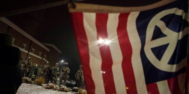 FERGUSON, MO - NOVEMBER 26: Members of Missouri National Guard are deployed outside the Ferguson Police Department during continued demonstrations after the Grand Jury did not indict white Police Officer Darren Wilson in the shooting death of black 18-year old Michael Brown in Ferguson, Mo. on November 26, 2014. (Photo by Samuel Corum/Anadolu Agency/Getty Images)