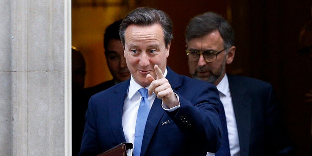 Britain's Prime Minister David Cameron points towards the media as he leaves 10 Downing Street in London, Thursday, Nov. 20, 2014. David Cameron will attend a Liaison Committee Thursday, the meeting focuses on the Governance of the UK in the light of the Scottish Referendum. (AP Photo/Kirsty Wigglesworth)