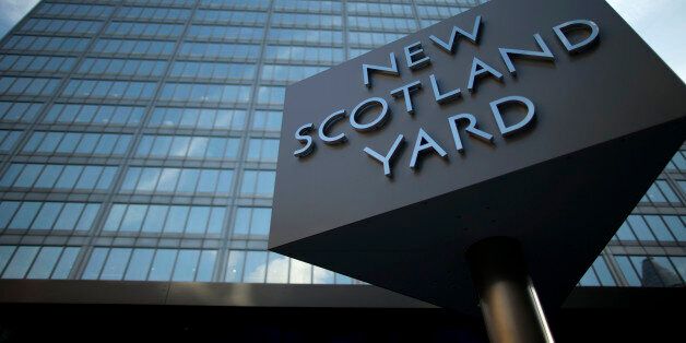 A sign rotates outside New Scotland Yard, the headquarters building of London's Metropolitan Police force in central London, Tuesday, Oct. 30, 2012. London's police force says it will move from its headquarters at New Scotland Yard as it faces making budget cuts of more than 500 million pounds ($800 million). Deputy Commissioner Craig Mackey told the mayor's office Tuesday that it plans to save 6.5 million pounds per year by moving to a smaller building. (AP Photo/Matt Dunham)