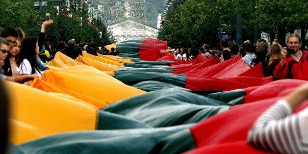Lithuanians carry a 1000 metre long Lithuanian flag as they march during a celebration of the 25th anniversary of the Baltic Way in Vilnius on August 23, 2014. The Baltic states on Saturday marked 25 years since two million people joined hands in a landmark human chain linking up their capitals to demand freedom from the Soviet Union. AFP PHOTO / PETRAS MALUKAS (Photo credit should read PETRAS MALUKAS/AFP/Getty Images)