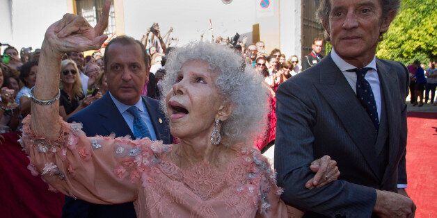 Maria del Rosario Cayetana Alfonsa Victoria Eugenia Francisca Fitz-James Stuart y de Silva, Spanish Duchess of Alba, reacts in presence of her husband Alfonso Diez after their wedding at Las Duenas Palace in Seville, Spain Wednesday Oct. 5, 2011. A wealthy, 85-year-old Spanish Duchess of Alba considered the world's most title-laden noble married a civil servant 25 years her junior, shrugging off her children's qualms and celebrating by kicking off her shoes and dancing a bit of flamenco.(AP Photo/Miguel Angel Morenatti)