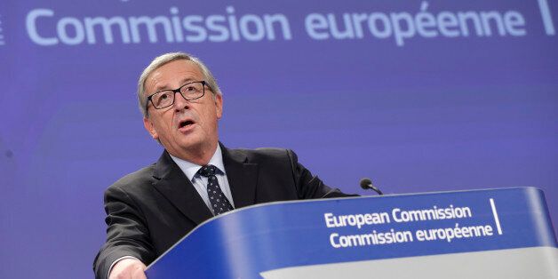 European Commission President Jean-Claude Juncker addresses the media at the European Commission headquarters in Brussels, Wednesday, Nov. 12, 2014. European Commission President Jean-Claude Juncker defended himself against allegations he should have done more to counter tax practices in his country that are widely seen as having sheltered many multinationals and the super rich from paying more taxes in their home nations. (AP Photo/Yves Logghe)