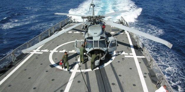 Navy technicians of the Turkish frigate, TCG Gemlik, prepare a Sikorsky SH70-B Seahawk helicopter for flight during a mock search and rescue exercise by Turkish and Turkish Cypriot forces on Wednesday, June 17, 2009 off Cyprus, where tensions run high over Greek Cypriot plans to expand search for oil and gas despite strong objections by Turkey. (AP Photo/ Selcan Hacaoglu)