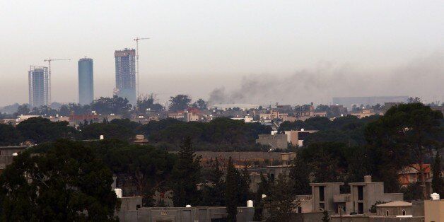 Smoke billows on November 25, 2014 from the Mitiga airport in an eastern suburb of the Libyan capital Tripoli held by anti-government militias, after an airstrike by forces loyal to Libya's internationally recognised government. More than three years after dictator Moamer Kadhafi was toppled and killed in a NATO-backed revolt, Libya is awash with weapons and powerful militias, and run by rival governments and parliaments. AFP PHOTO / MAHMUD TURKIA (Photo credit should read MAHMUD TURKIA/AFP/Getty Images)