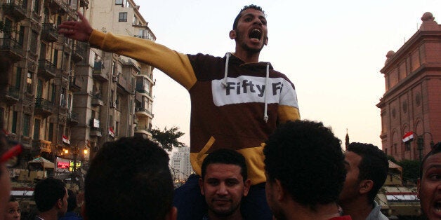 CAIRO, EGYPT - NOVEMBER 29: Hundreds of Egyptian people protest the court verdict, dropping charges against former Egyptian president Hosni Mubarak that he incited the killing of protesters in 2011, at Abdul Munim Riad Square in Cairo, Egypt on November 29, 2014. (Photo by Ahmed Taranh/Anadolu Agency/Getty Images)