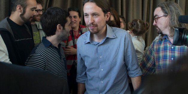 FILE - In this May 30, 2014 file photo, Pablo Iglesias, the leader of the leftist Podemos (We Can) party, centre, leaves a news conference in Madrid, Spain. A poll shows the recently-formed Spanish leftist party Podemos has risen to become the most popular choice among Spanish voters. A poll by private pollster Metroscopia, published Sunday Nov. 2, 2014 by newspaper El Pais, shows 27.7 percent of voters would choose Podemos if parliamentary elections were held tomorrow, against 26.2 percent for